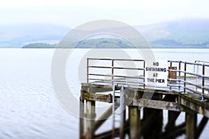 No swimming at pier jetty deep water Loch Lomond Luss warning sign danger of death