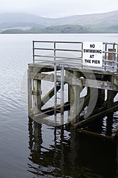 No swimming at pier jetty deep water Loch Lomond Luss warning sign danger of death