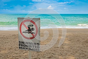 No swimming sign on beach .