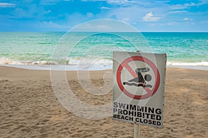 No swimming sign on beach .