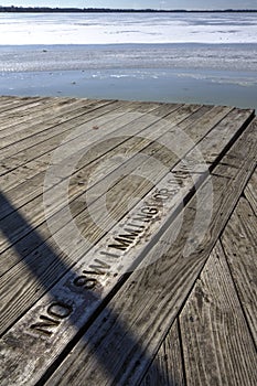 No swimming sign and icy lake