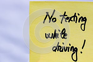 No texting while driving handwriting text close up isolated on yellow paper with copy space