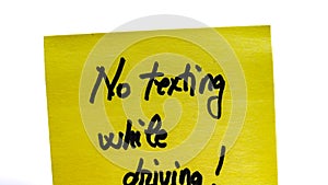 No texting while driving handwriting text close up isolated on yellow paper with copy space