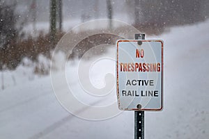 No Trespassing: Active Rail Line on sign in winter