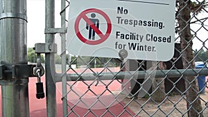 no trespassing facility closed for winter sign with illustration of crossed out