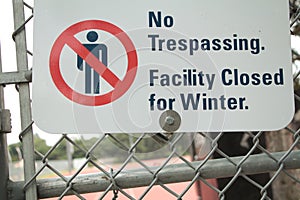 no trespassing facility closed for winter sign with illustration of crossed out. p