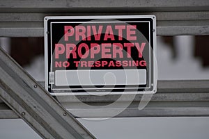 No Trespassing or Hunting sign posted for rural wooded property during winter