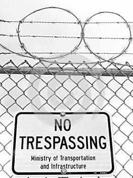 No Trespassing Sign with Barb Wire