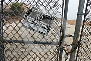 No Trespassing sign on chain link fence.