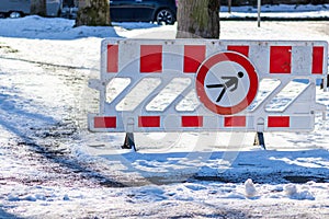 No trespassing sign shows danger in winter as warning of slippery road and slippery snow after snowfall with icy road insurance