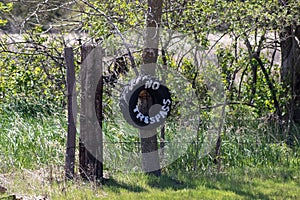 No Trespassing tire sign on barb wire fence