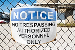 No trespassing warning sign on chain link fence