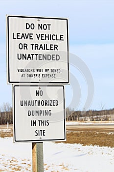 No Unattended Vehicles or Dumping Sign Along a Highway