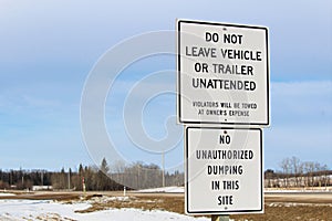 No Unattended Vehicles or Dumping Sign Along a Highway