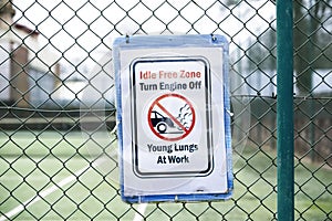 No vehicle idle idling emissions pollution young lungs at play sign outside school photo