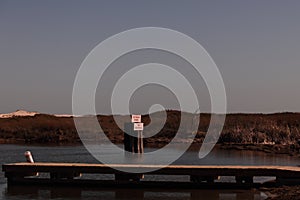 No Wake Zone Sign, Boat Ramp and Pier in the Sunshine