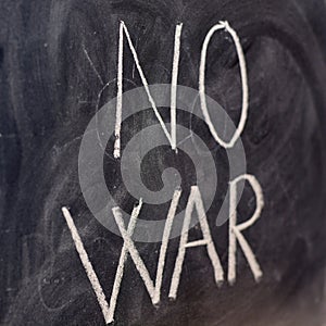 No war, handwritten with a chalk on the blackboard photo