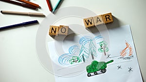 No war phrase on cubes, military situation drawing on table, political problems