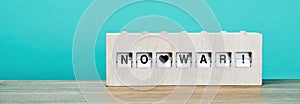 No war in a wooden split flap display, web banner