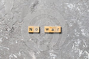 No war word written on wood block. No war text on table, concept