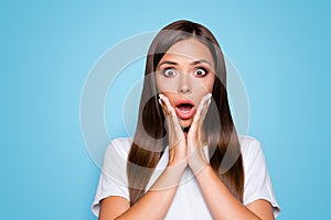 NO WAY Close up portrait of frustrated girl with wide open eyes mouth holding palms near cheeks looking at camera