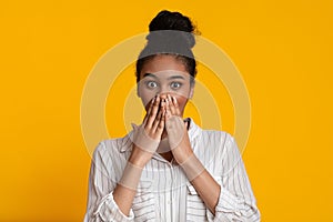 No way. Shocked black girl covering mouth with hands in amazement