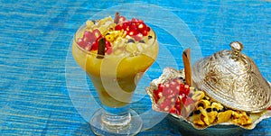 Noah`s pudding in white bowl. The dried fruits, legumes and cereals are made with wheat and sugar. It is decorated with walnut, dr