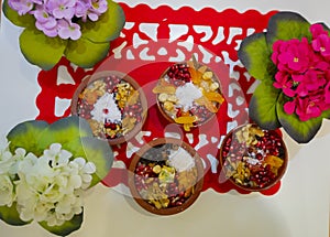 Noah`s pudding in white bowl. The dried fruits, legumes and cereals are made with wheat and sugar. It is decorated with walnut, dr