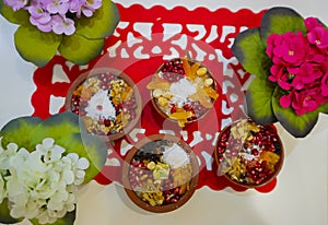 Noah`s pudding in white bowl. The dried fruits, legumes and cereals are made with wheat and sugar. It is decorated with walnut, dr