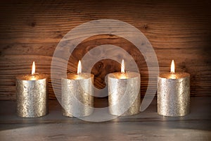 Noble candles against a background of wood