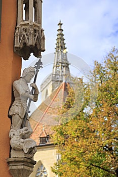 Noble crusader with spear above the fallen dragon statues