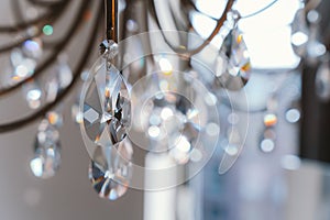 Noble and luxurious crystal chandelier light. Closeup crystal pendants of the chandelier, blur background, glamour