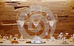 Noble wine glasses and crystal figures in the illuminated cabinet