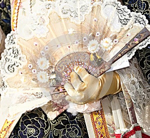 Noble woman with the luxurious dress and the fan