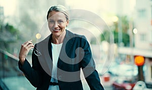 Nobody knows the business world quite like me. Portrait of a mature businesswoman standing outside on the balcony of her
