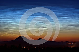 Noctilucent clouds above the hills