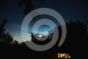 Noctilucent clouds on a summer evening in a Ukrainian village