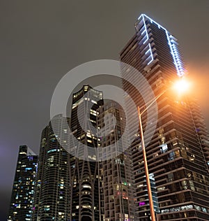 Nocturnal architecture. Skyscrapers lit up in Miami, USA. Illuminated architecture. Night city