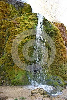 Nohn, Germany - 01 13 2021: cave trance behind the water of moss waterfall DreimÃ¼hlenwasserfall