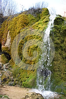 Nohn, Germany - 01 13 2021: splashing water on the cave side of moss waterfall DreimÃ¼hlenwasserfall