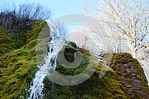 Nohn, Germany - 01 13 2021: splashing water on the higher part of moss waterfall DreimÃ¼hlenwasserfall