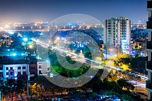 Noida cityscape at night with light trails on road photo
