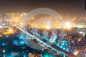 Noida metro station at night against the cityscape