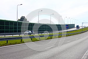 Noise barrier, acoustic screen, highway, cars on the sound-absorbing tunnel