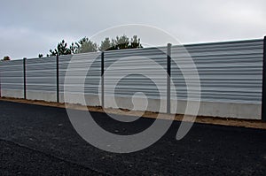 noise barrier made of metal perforated sheet metal slats.