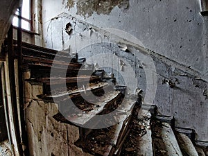 Noisy image of desolate staircase in an abandoned building