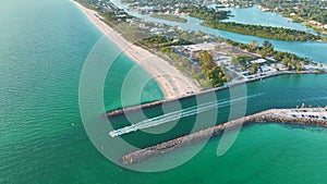 Nokomis beach ocean inlet with sailing boats and North and South Jetty in Sarasota county, USA. Many people enjoying