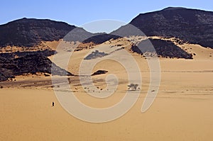 Nomad crossing a vast desert landscape photo