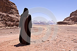 Nomadic woman with burka in wadi rum photo