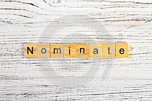 NOMINATE word made with wooden blocks concept photo